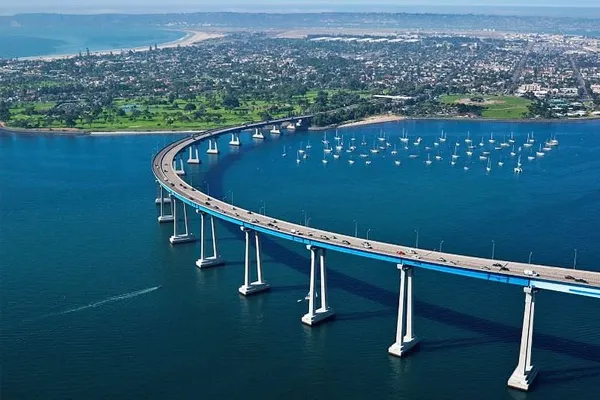 Aerial view of the Coronado Bridge at sunset, representing the secure legal pathways and interlocking structures of tax-efficient asset transfers.